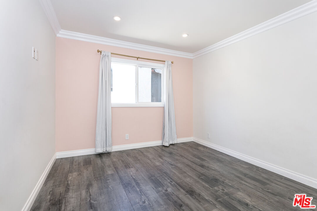 7001 Beckett Street Tujunga, CA 91042 - Photo 10 of 21 an empty room with wooden floor and windows