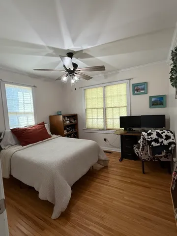 a bedroom with bed window and couch