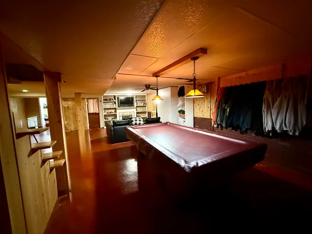 a view of a patio with furniture wooden floor and a flat screen tv