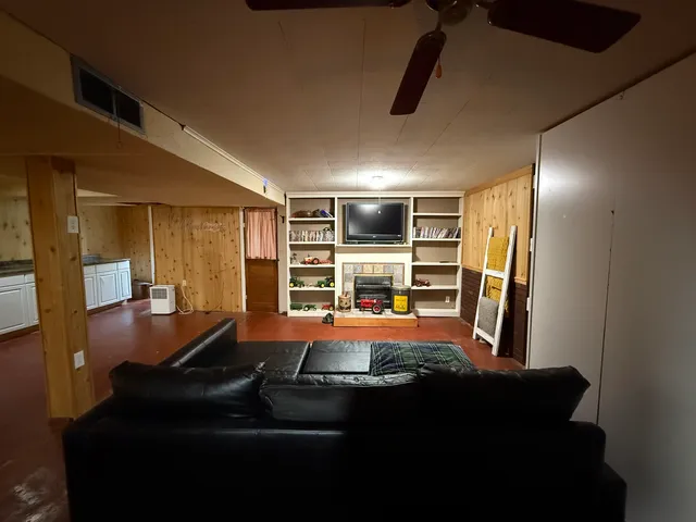 a room with furniture and a ceiling fan