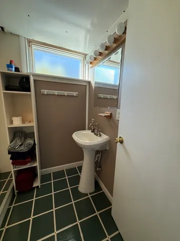 a bathroom with a sink toilet and a mirror