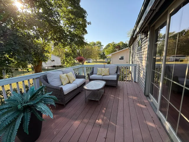 a view of balcony with couches and wooden floor