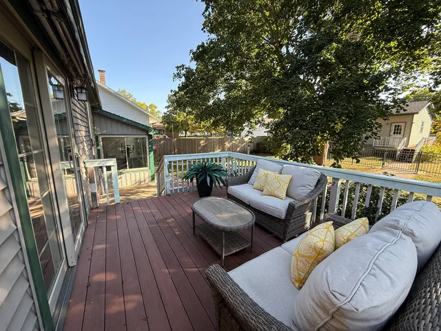 a view of balcony with furniture and wooden floor