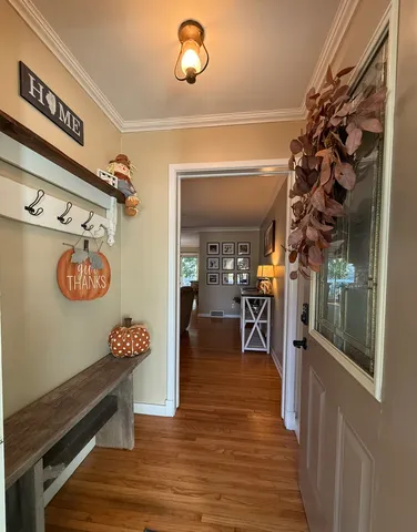 a view of a hallway with wooden floor