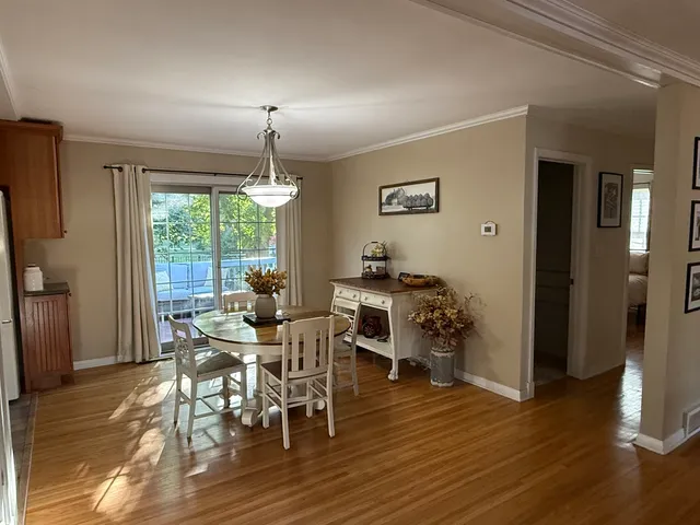 a dining room with furniture window and wooden floor