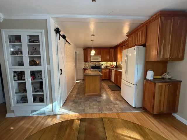 a kitchen with refrigerator and cabinets