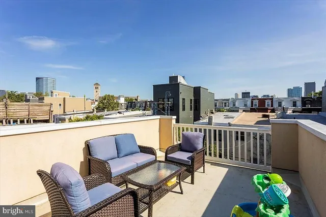 a living room with furniture and a kitchen view