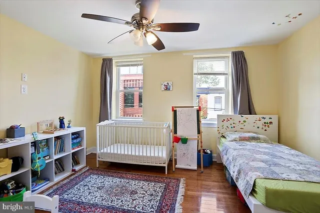 a bedroom with a bed a dresser and a book shelf