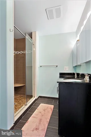 a kitchen with a refrigerator and a stove top oven