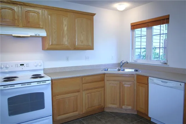a white toilet sitting next to a bathroom sink