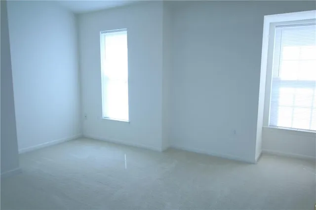 a white toilet sitting next to a bathroom sink and tub