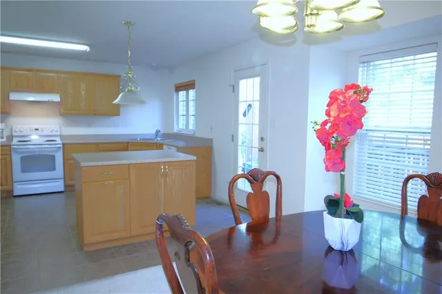 a kitchen with a stove a sink and a refrigerator