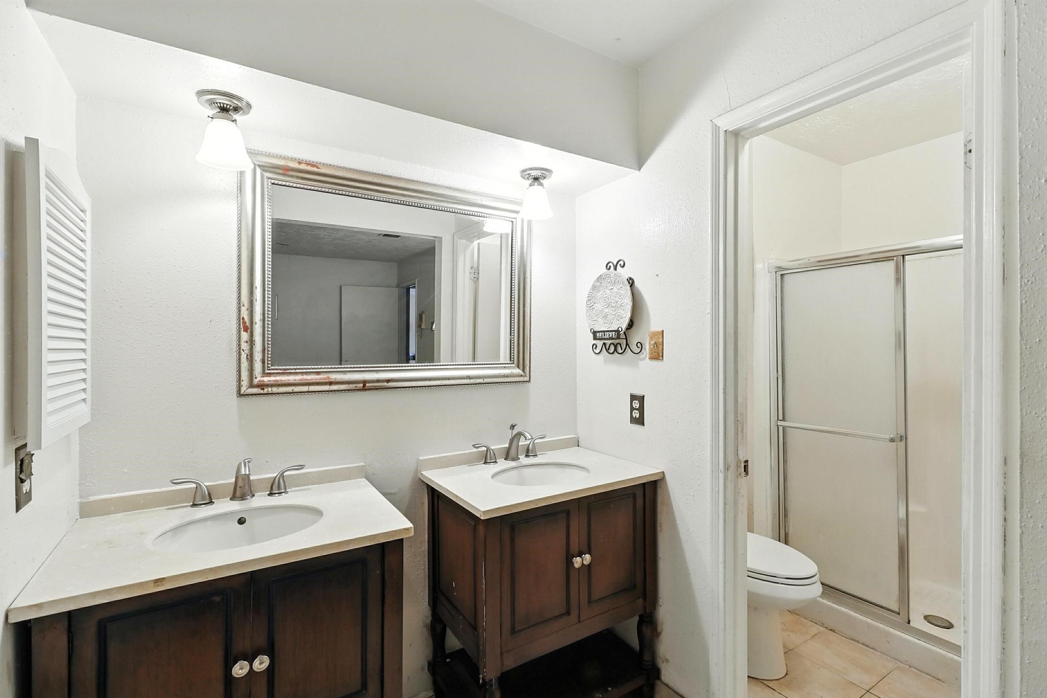 6911 Silver Star Drive Houston, TX 77086 - Photo 3 of 15 a bathroom with a sink vanity and a toilet