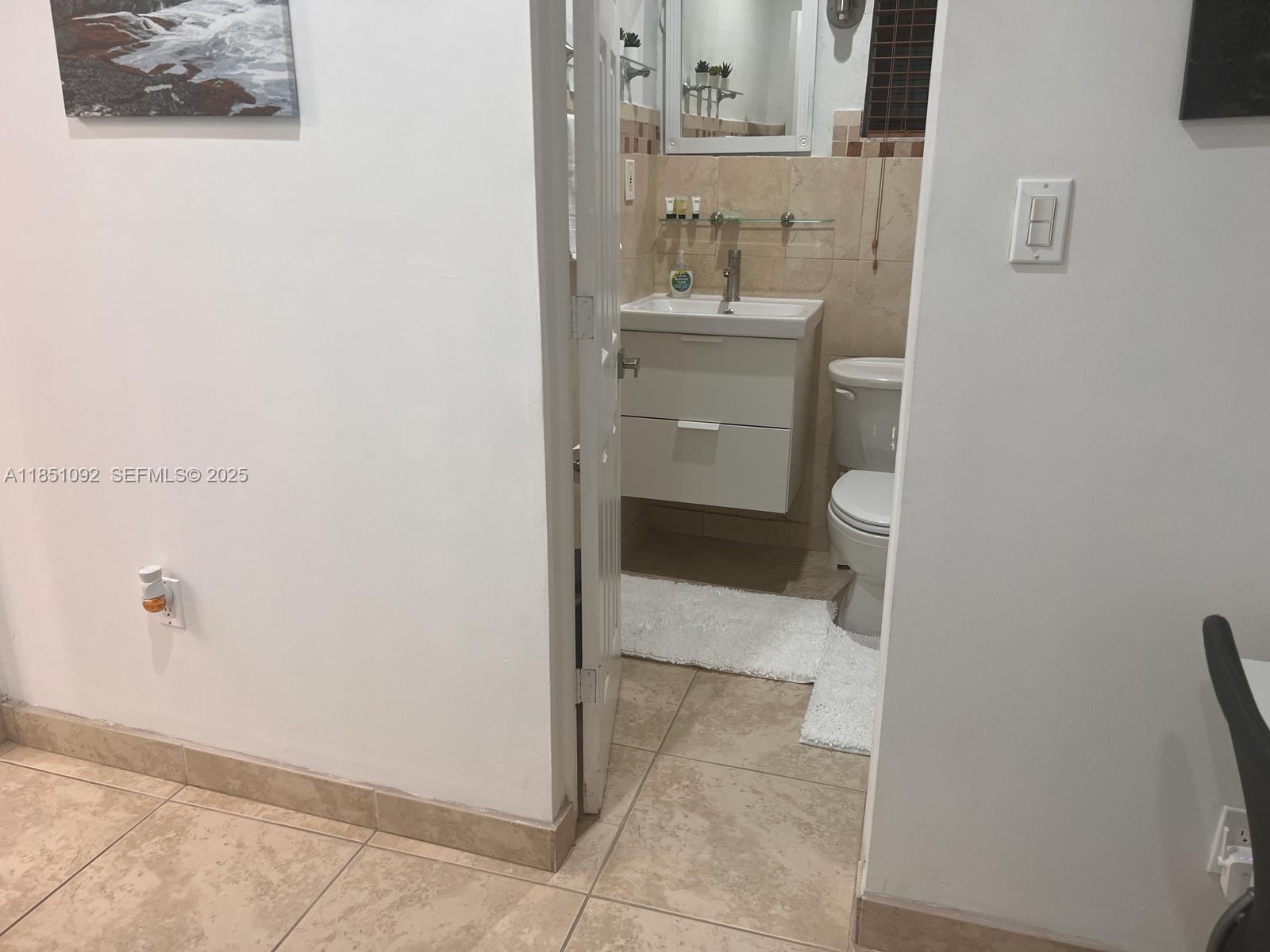 1721 Southwest 24th Terrace Miami, FL 33145 - Photo 67 of 80 a bathroom with a sink and mirror