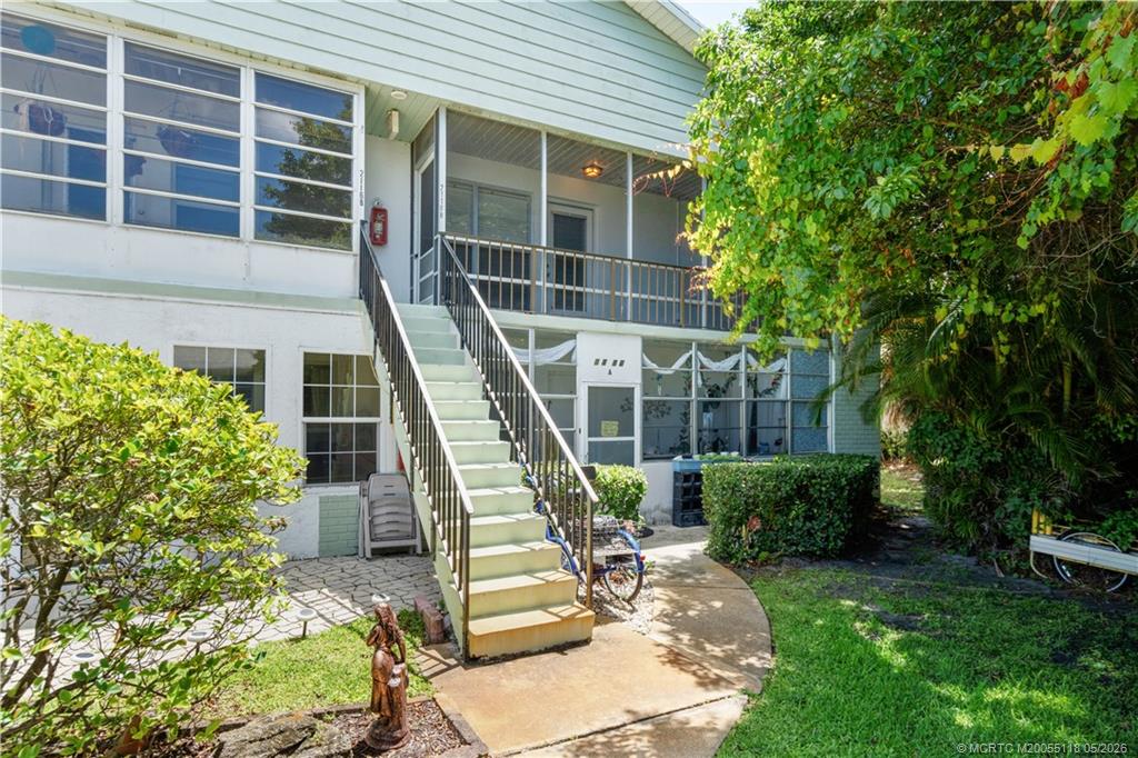 2118 Southeast Edler Drive, Unit B Stuart, FL 34994 - Photo 19 of 20 a front view of a house with garden