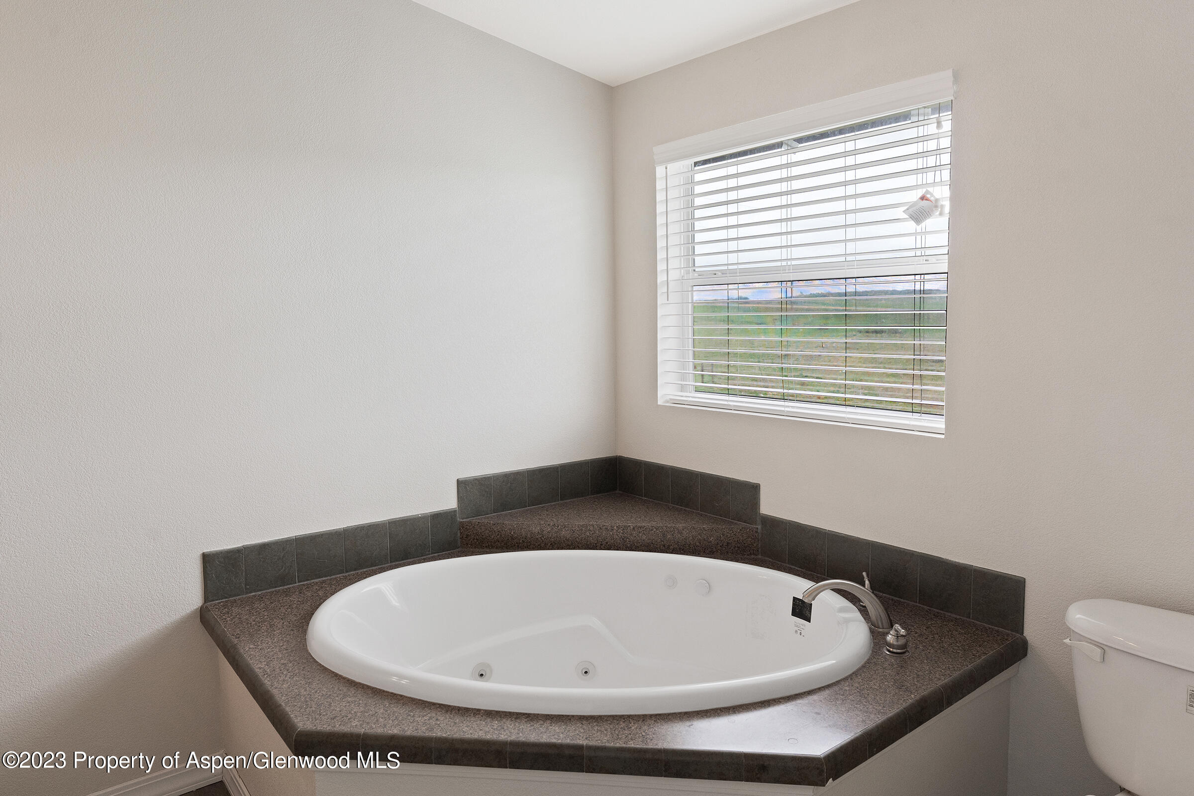 378 Sunset Drive Craig, CO 81625 - Photo 19 of 22 a bathroom with a toilet and a window