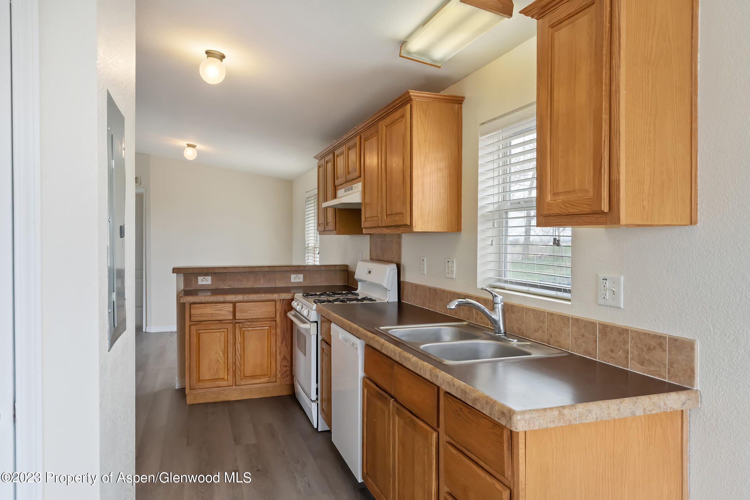 378 Sunset Drive Craig, CO 81625 - Photo 5 of 22 a kitchen with stainless steel appliances granite countertop a sink stove and cabinets