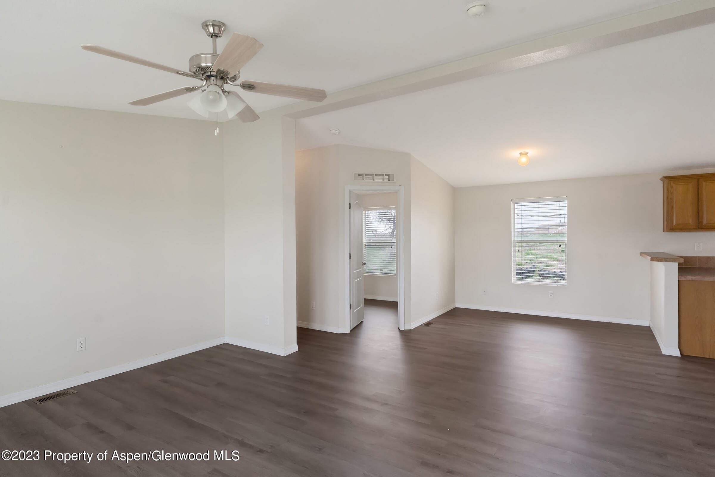378 Sunset Drive Craig, CO 81625 - Photo 7 of 22 a view of an empty room with a window and wooden floor