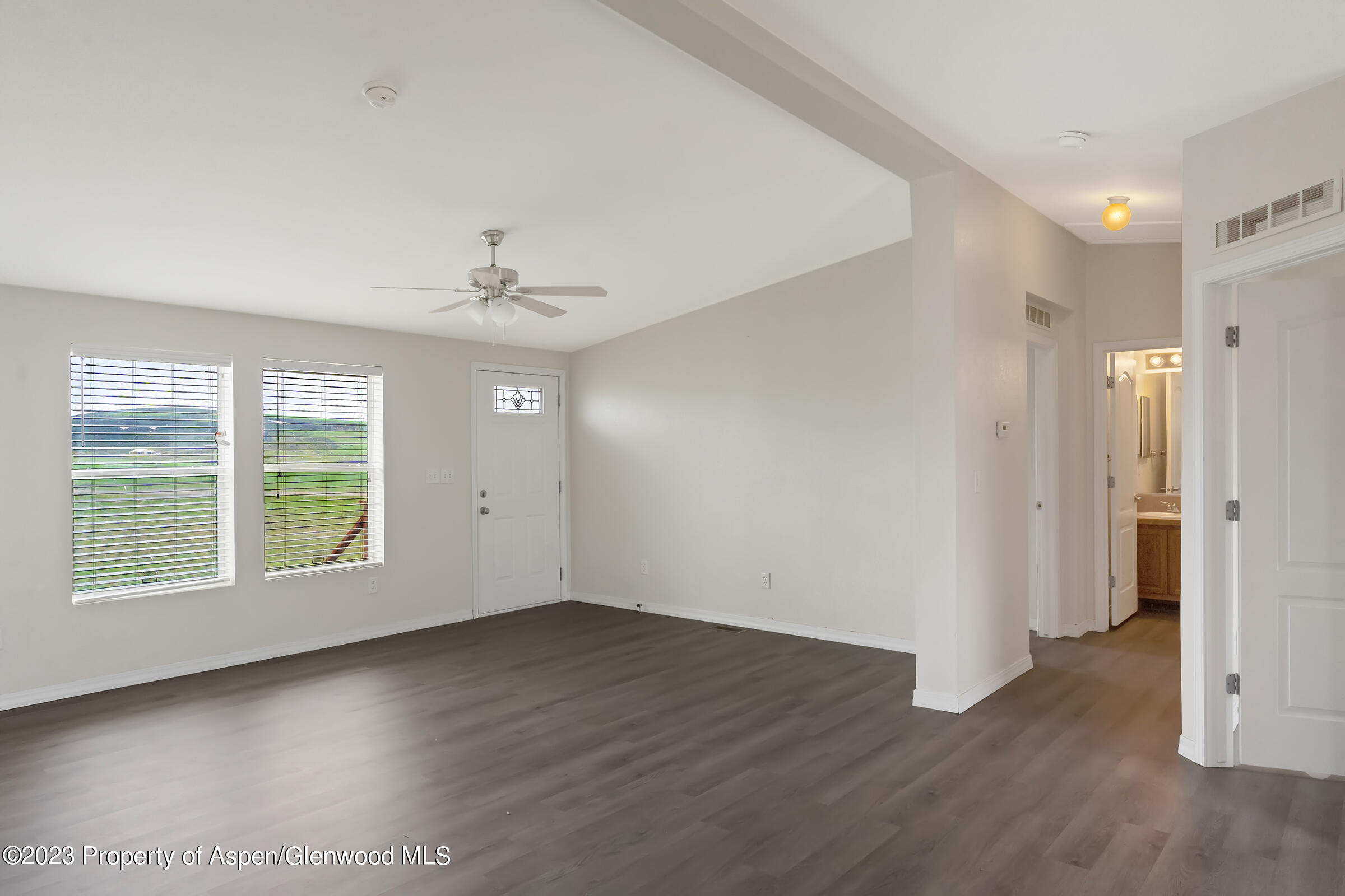 378 Sunset Drive Craig, CO 81625 - Photo 10 of 22 wooden floor in an empty room with a window