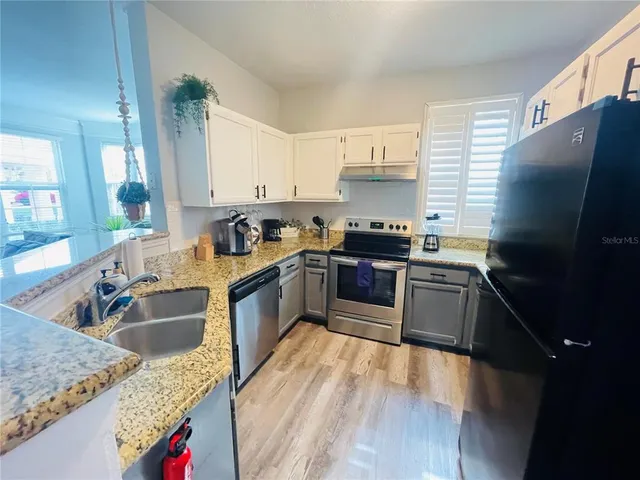 a kitchen with a sink stove and cabinets
