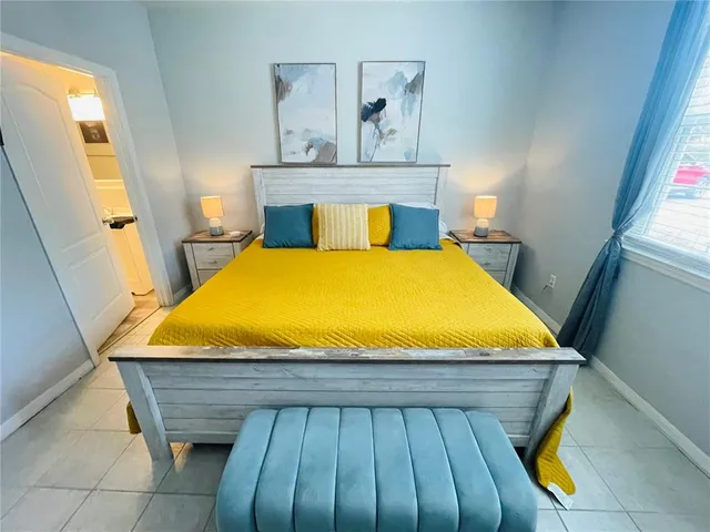 a bed sitting in a bedroom next to a window