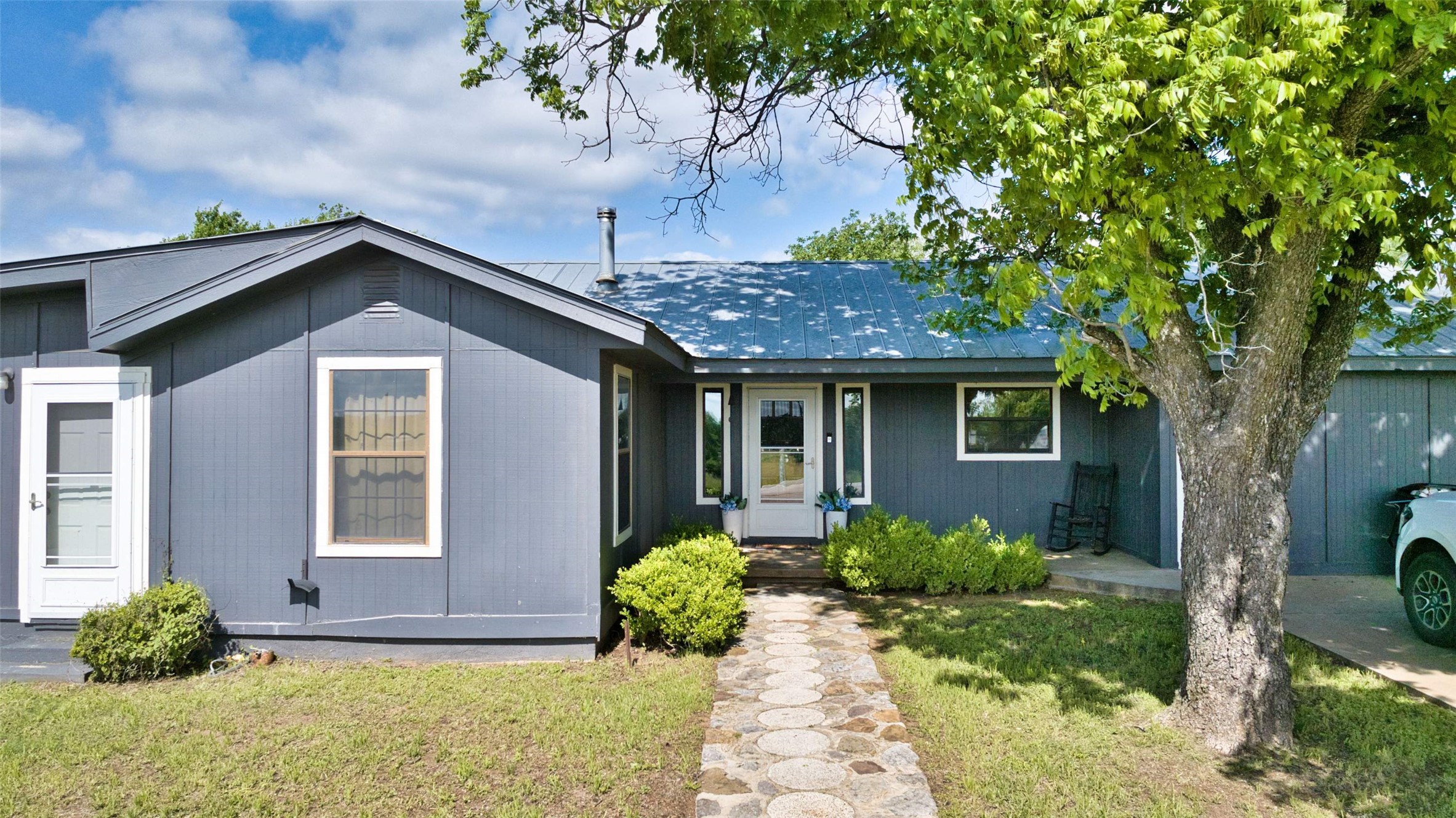 904 Bluebonnet Road Mason, TX 76856 - Photo 1 of 28 Dark gray siding exterior with a light blue metal roof