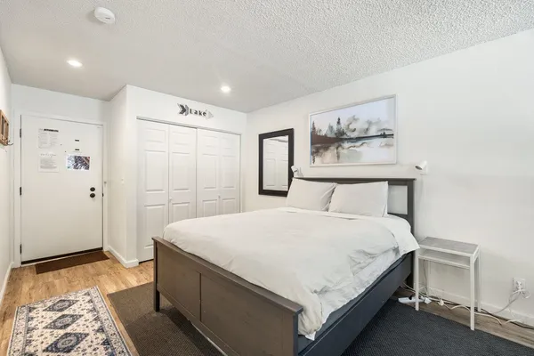 a large bed sitting in a bedroom and a table