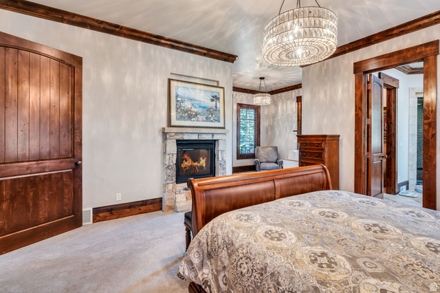 811 South High Ridge Drive Alpine, UT 84004 - Photo 26 of 98 Carpeted bedroom featuring ornamental molding, a fireplace, and hanging lights