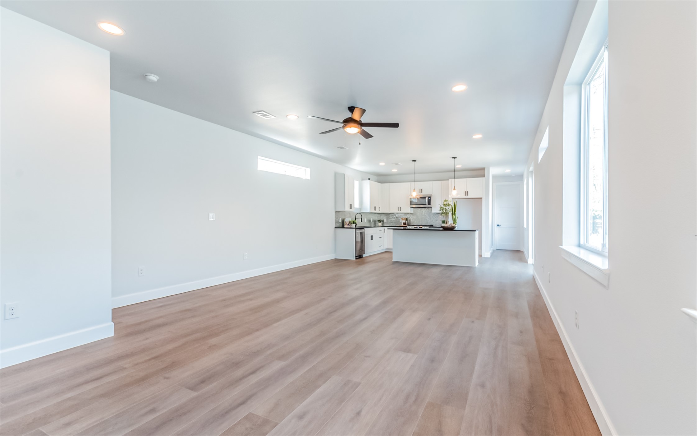 1130 Spur Street, Unit A Austin, TX 78721 - Photo 5 of 31 Unfurnished living room featuring ceiling fan and recessed lighting