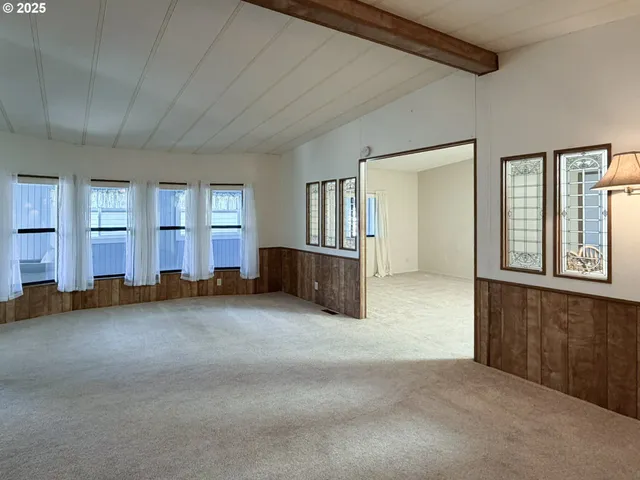 an empty room with windows and pillars in it