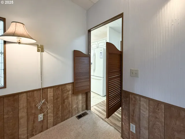 a view of a dining room with furniture and a window