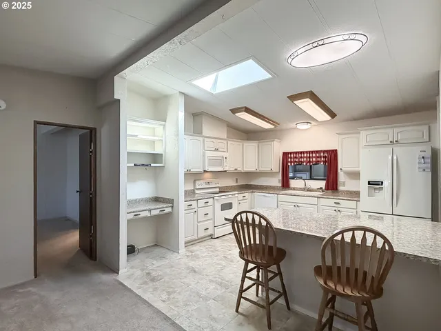 a kitchen with granite countertop cabinets stainless steel appliances and sink
