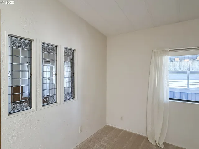 an empty room with windows and closet