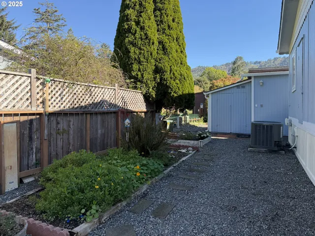 a view of a hallway with stairs and furniture