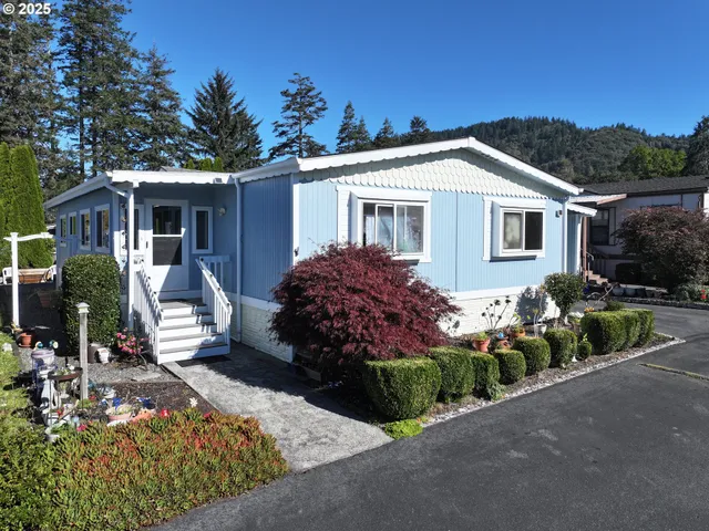 a front view of house with yard and trees around