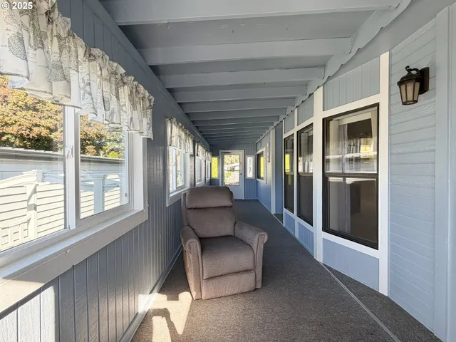 a living room with furniture and a floor to ceiling window