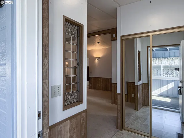 a bathroom with a glass shower door and a mirror