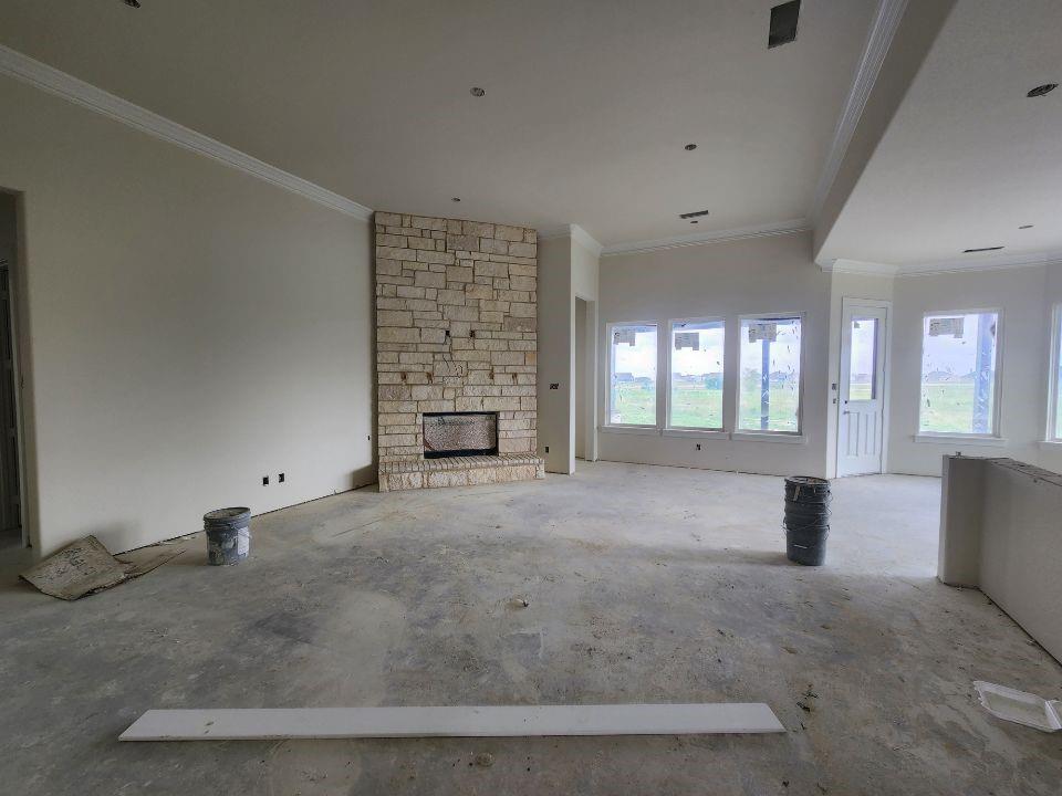 2320 Quartz Street Krum, TX 76249 - Photo 9 of 17 an empty room with fireplace and windows
