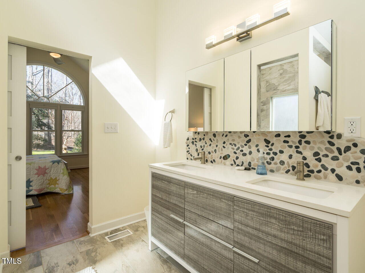 1048 Shadywood Lane Raleigh, NC 27603 - Photo 18 of 35 a bathroom with a sink a mirror and a shower