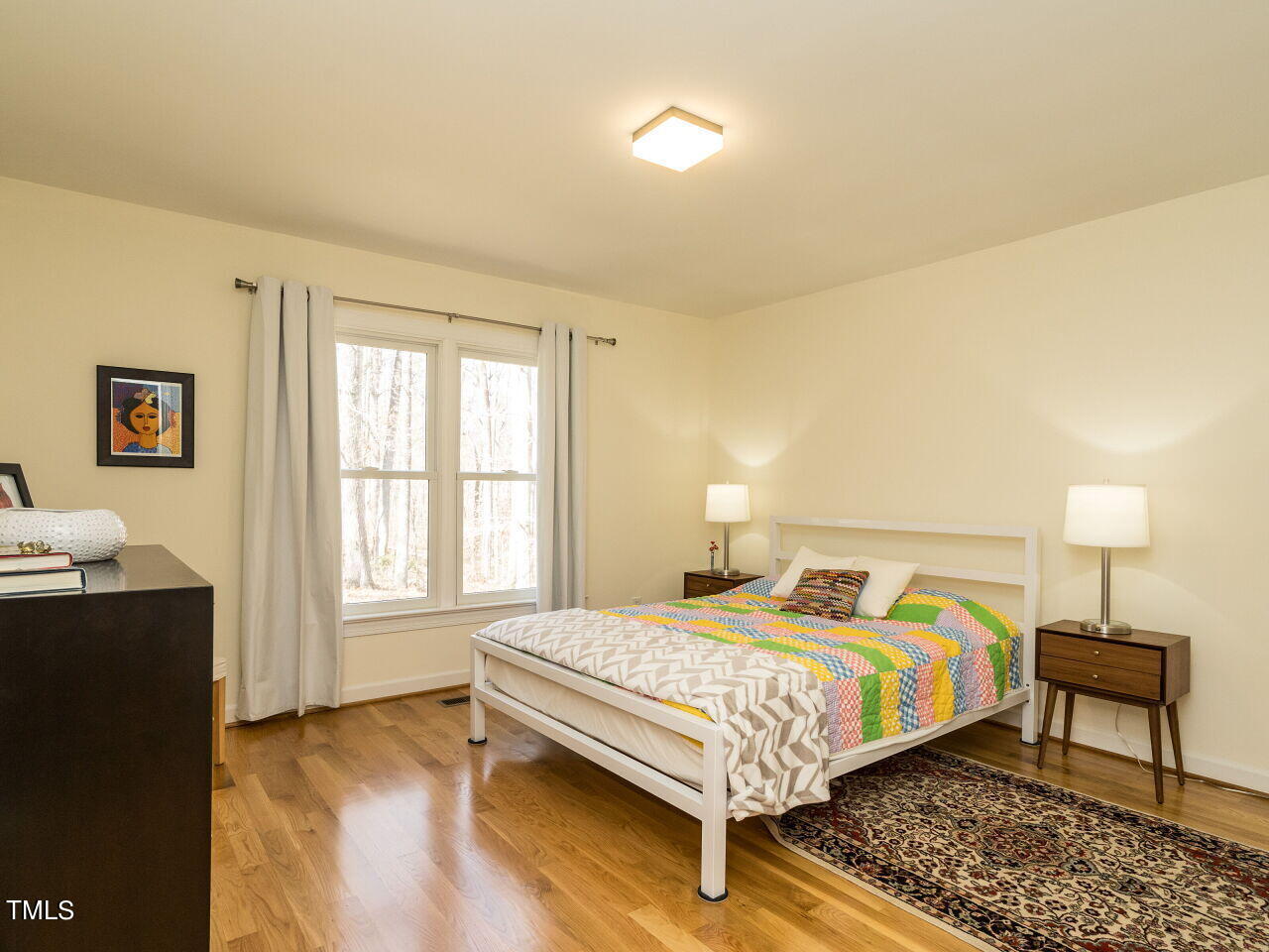 1048 Shadywood Lane Raleigh, NC 27603 - Photo 22 of 35 a bedroom with a bed lamps and window