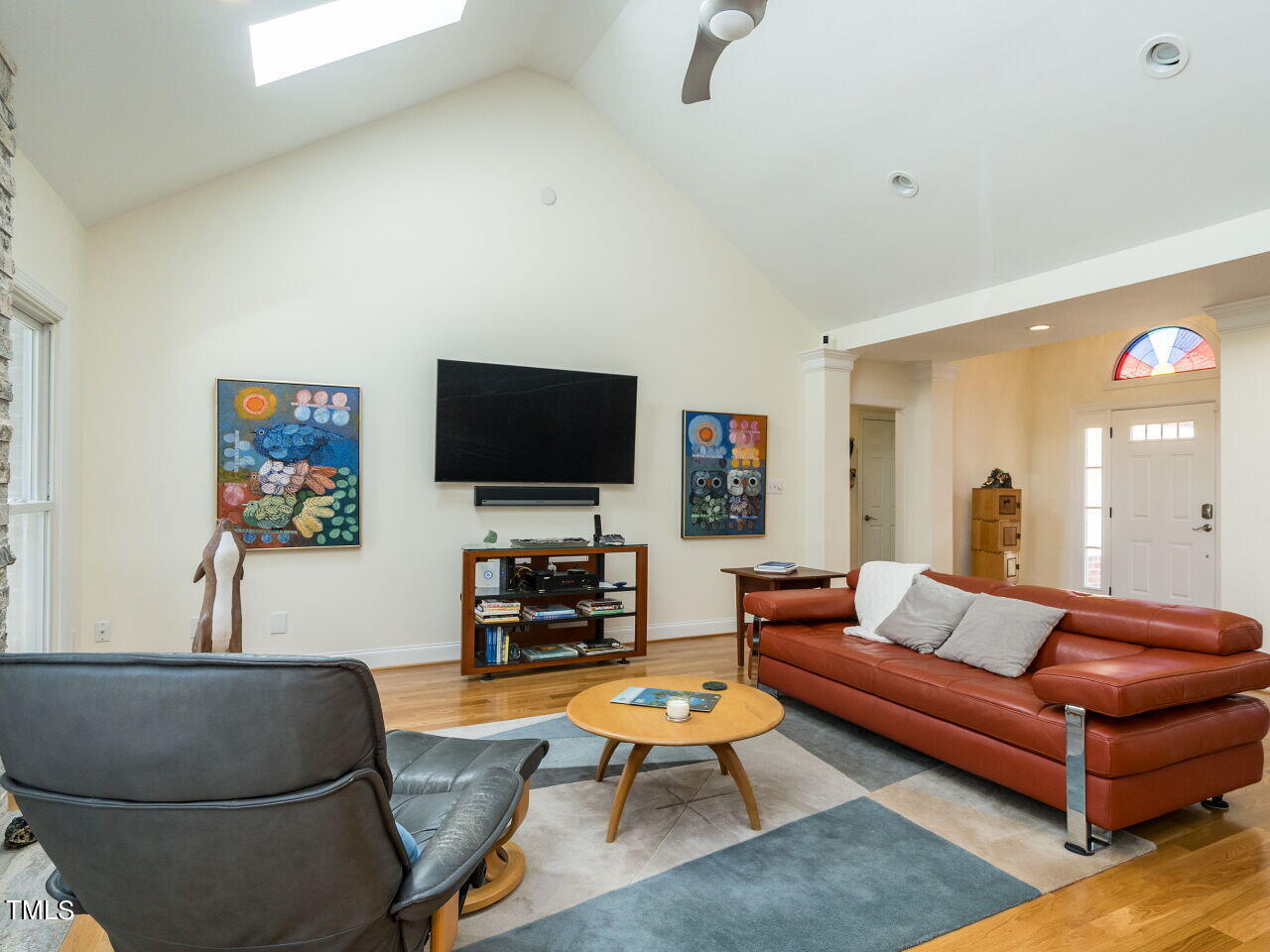 1048 Shadywood Lane Raleigh, NC 27603 - Photo 10 of 35 a living room with furniture and a flat screen tv