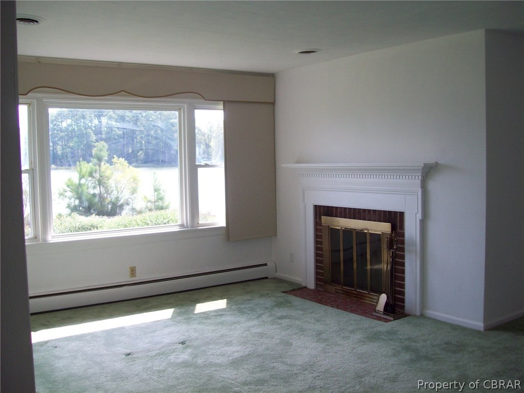 344 Ballast Point Road Hudgins, VA 23076 - Photo 4 of 12 an empty room with windows