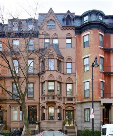 a front view of a residential apartment building with a yard