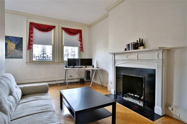 165 Beacon Street, Unit 8 Boston, MA 02116 - Photo 3 of 8 a living room with furniture and a fireplace