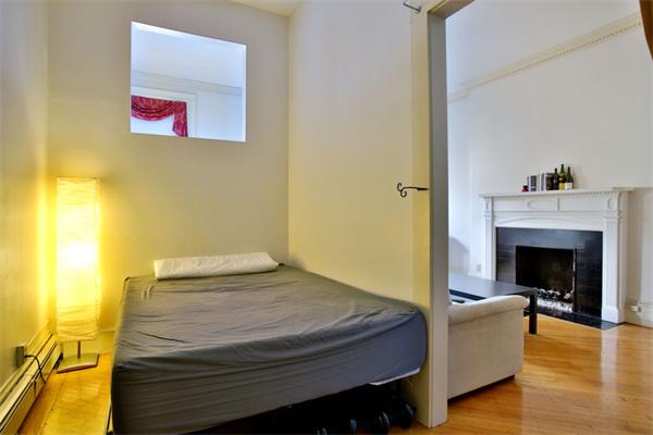 165 Beacon Street, Unit 8 Boston, MA 02116 - Photo 4 of 8 a bedroom with a bed and a fireplace