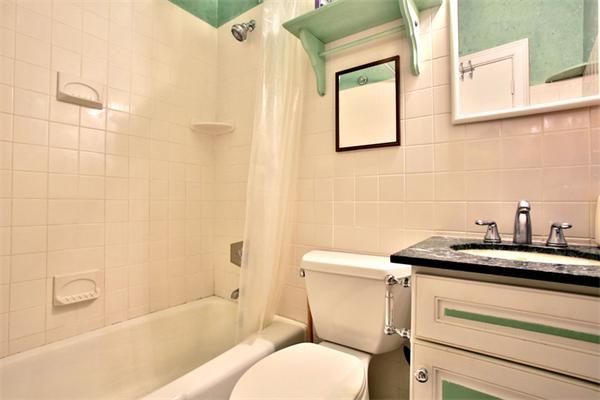 165 Beacon Street, Unit 8 Boston, MA 02116 - Photo 7 of 8 a bathroom with a granite countertop toilet sink and mirror
