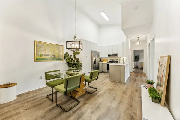 a living room with furniture and a dining table with kitchen view