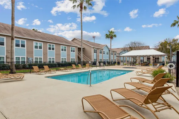 a view of a house with swimming pool and sitting area