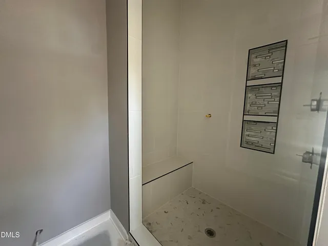 a spacious bedroom with a large bed and a chandelier