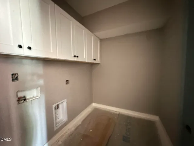 a view of storage and utility room with cabinet